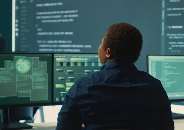 Governmental hackers analyzing big data for cyber threat detection, working at agency desks. Professional expert woman analyzes cyber intelligence and prevention of digital threats. Camera A.