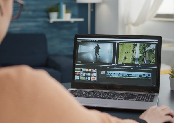 Design student working on video editing software to make montage, creating film for movie footage production. Content creator using multimedia assignment for online school class.
